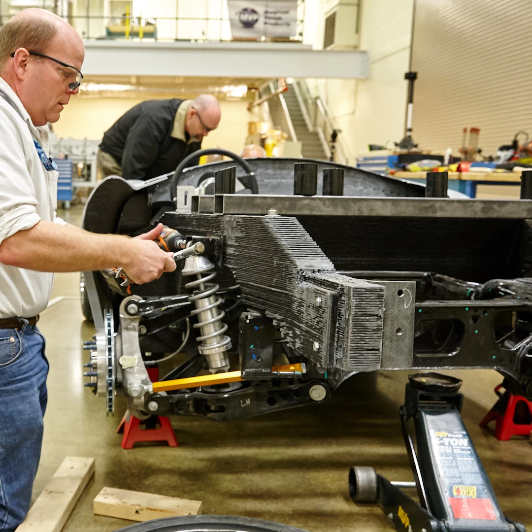 Rear view of a chassis of a 3d printed plastic cobra car during assembly