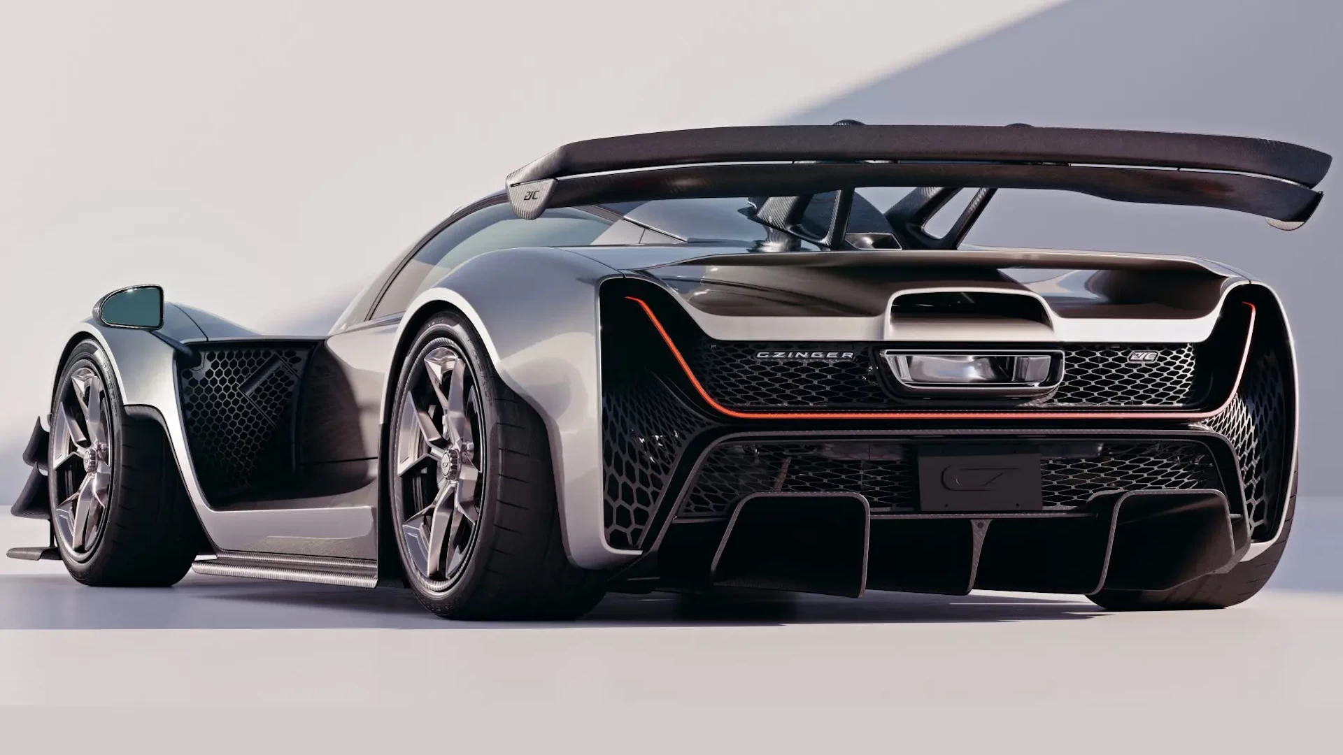 Rear left view of a sleek silver 3d printed supercar against a white background