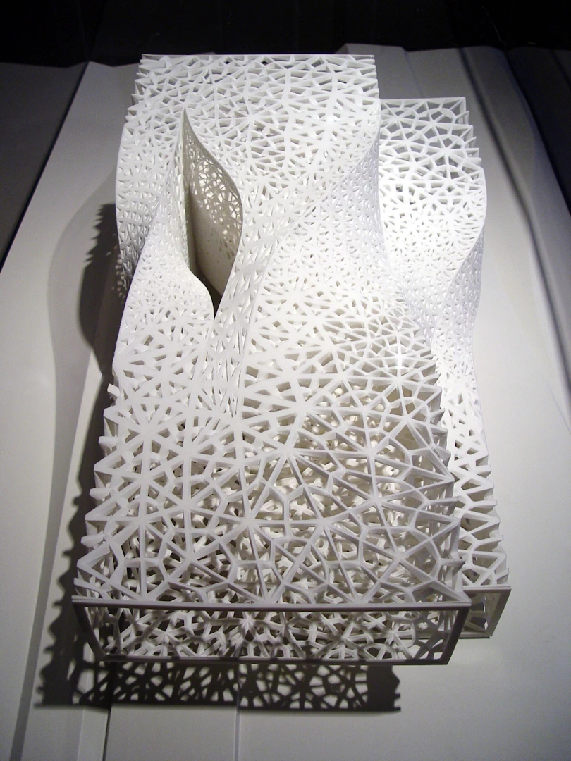 Top view of a white model building shaped with twisted rectangles and patterned walls 3d printed in sintered nylon