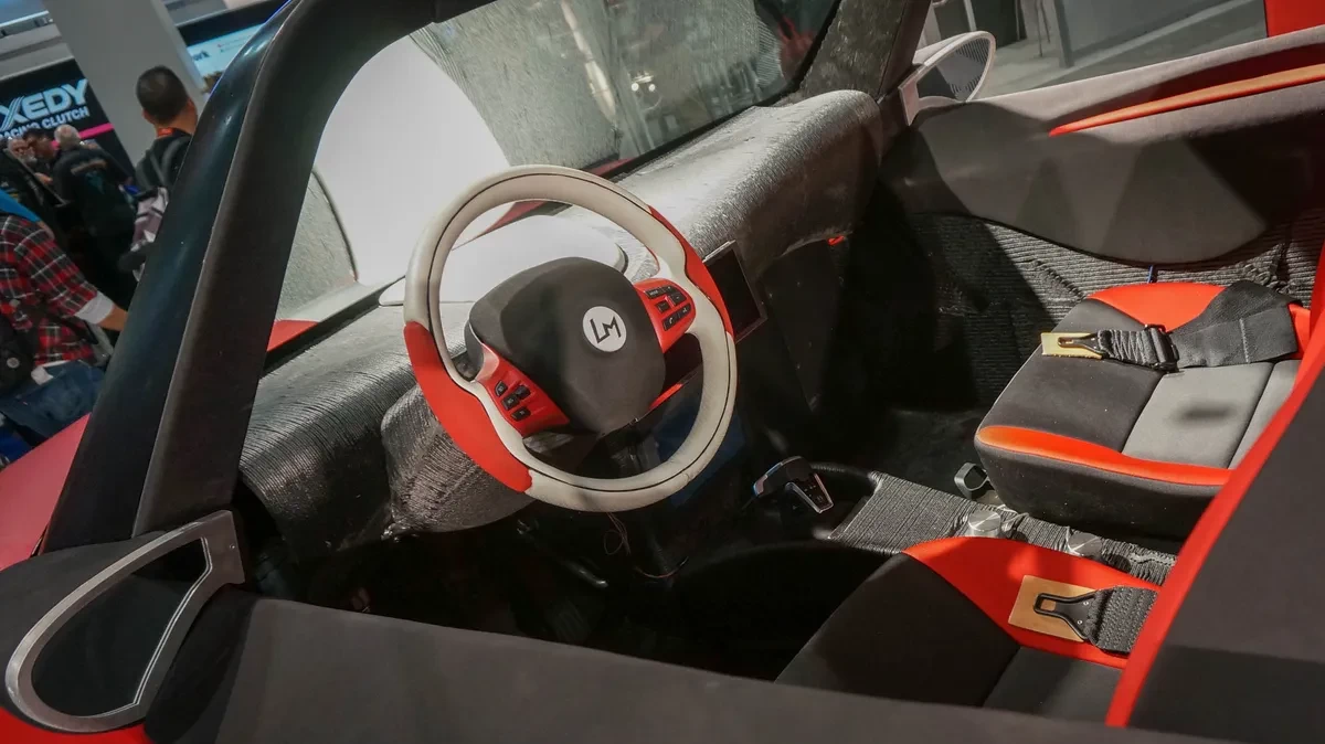 Cabin view of a red 3d printed plastic beach buggy at a car show