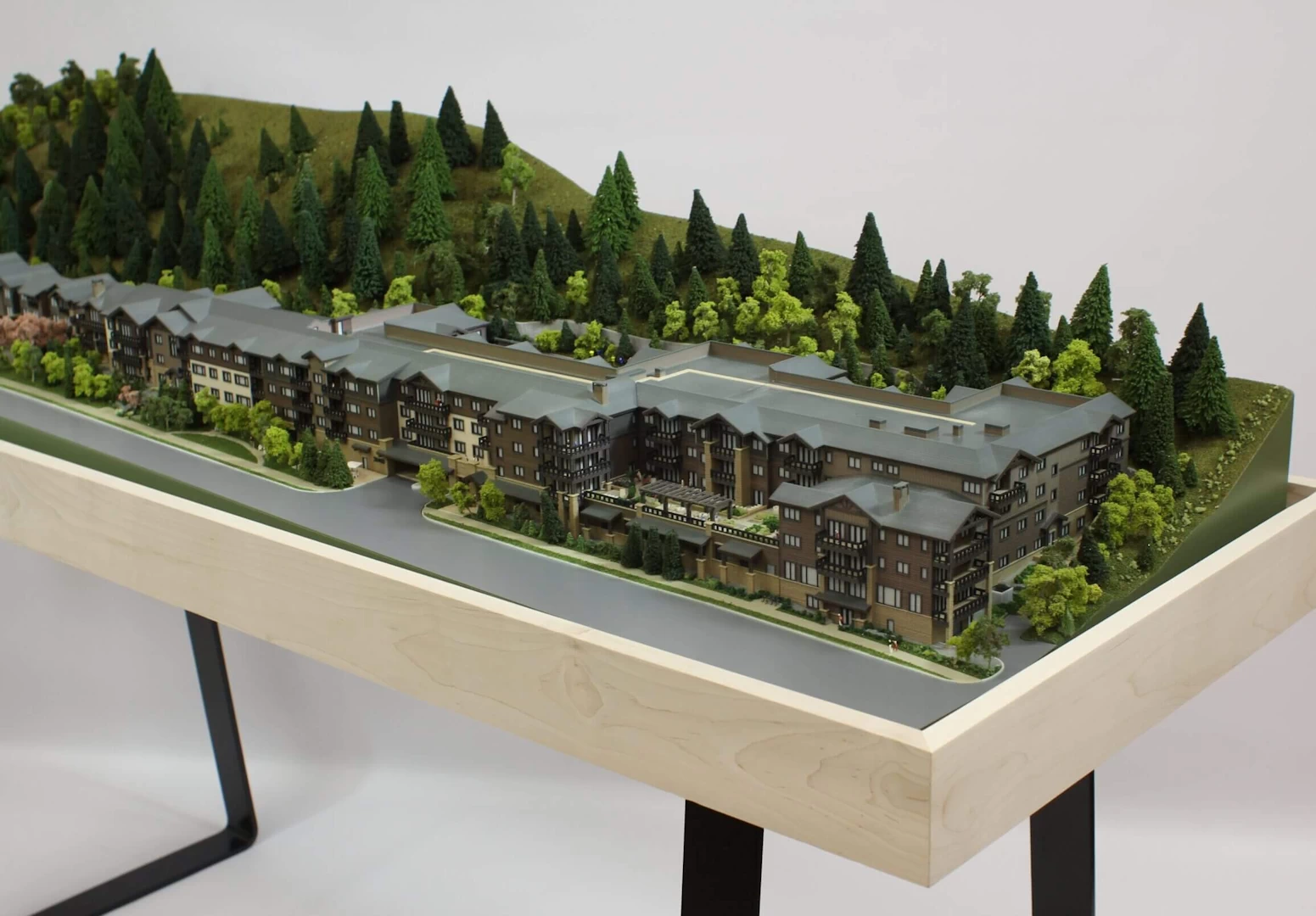 Overview of a 4 storey wood and stone residential complex in the mountains 3d printed in colour binder jetted powder