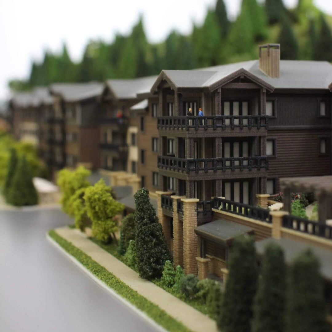 Side view of a 4 storey wood and stone residential complex in the mountains 3d printed in colour binder jetted powder
