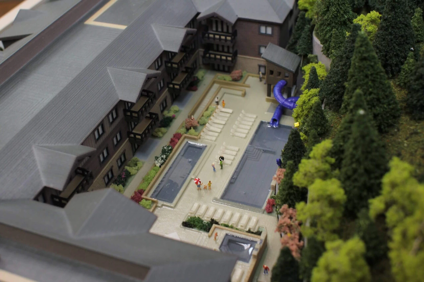 Top view of a 4 storey wood and stone residential complex in the mountains 3d printed in colour binder jetted powder