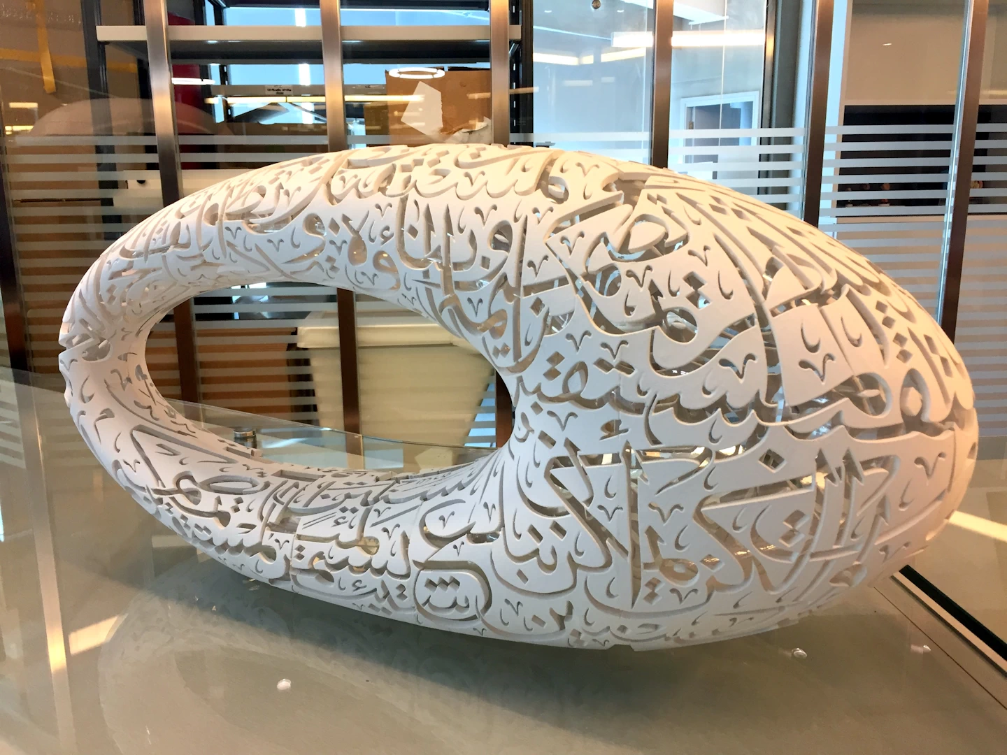 Side view of a white model of the oval donut shaped museum of the future in dubai 3d printed in binder jetted resin