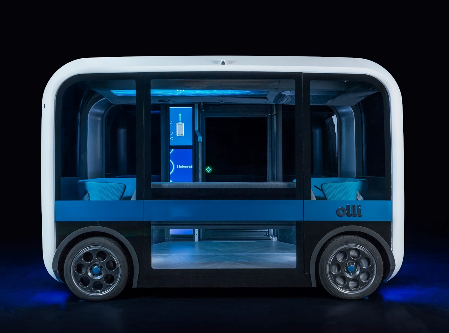 Side view of a futuristic black and white 3d printed plastic autonomous shuttle