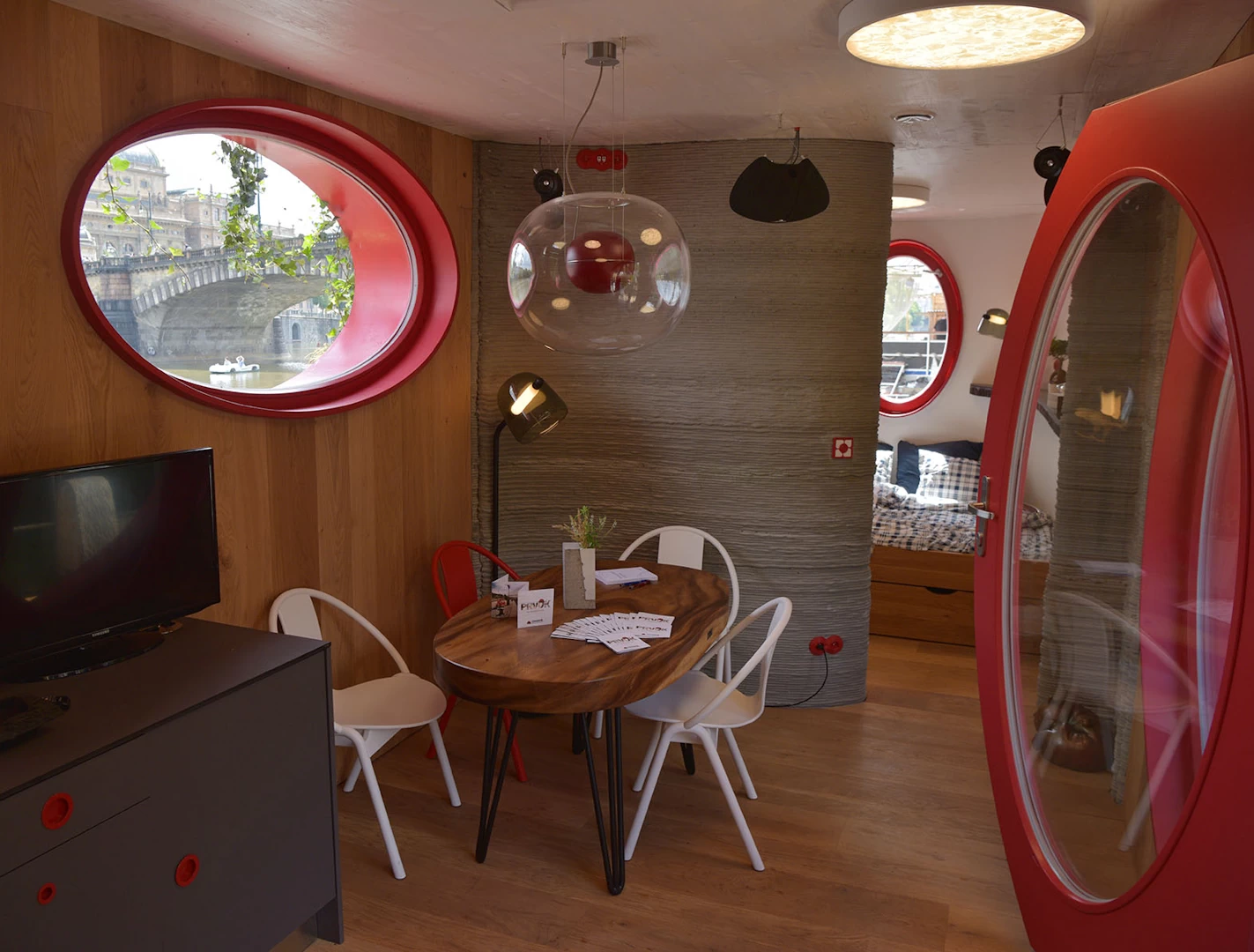 View of furnished lounge inside 3d printed concrete cottage with wooden flooring