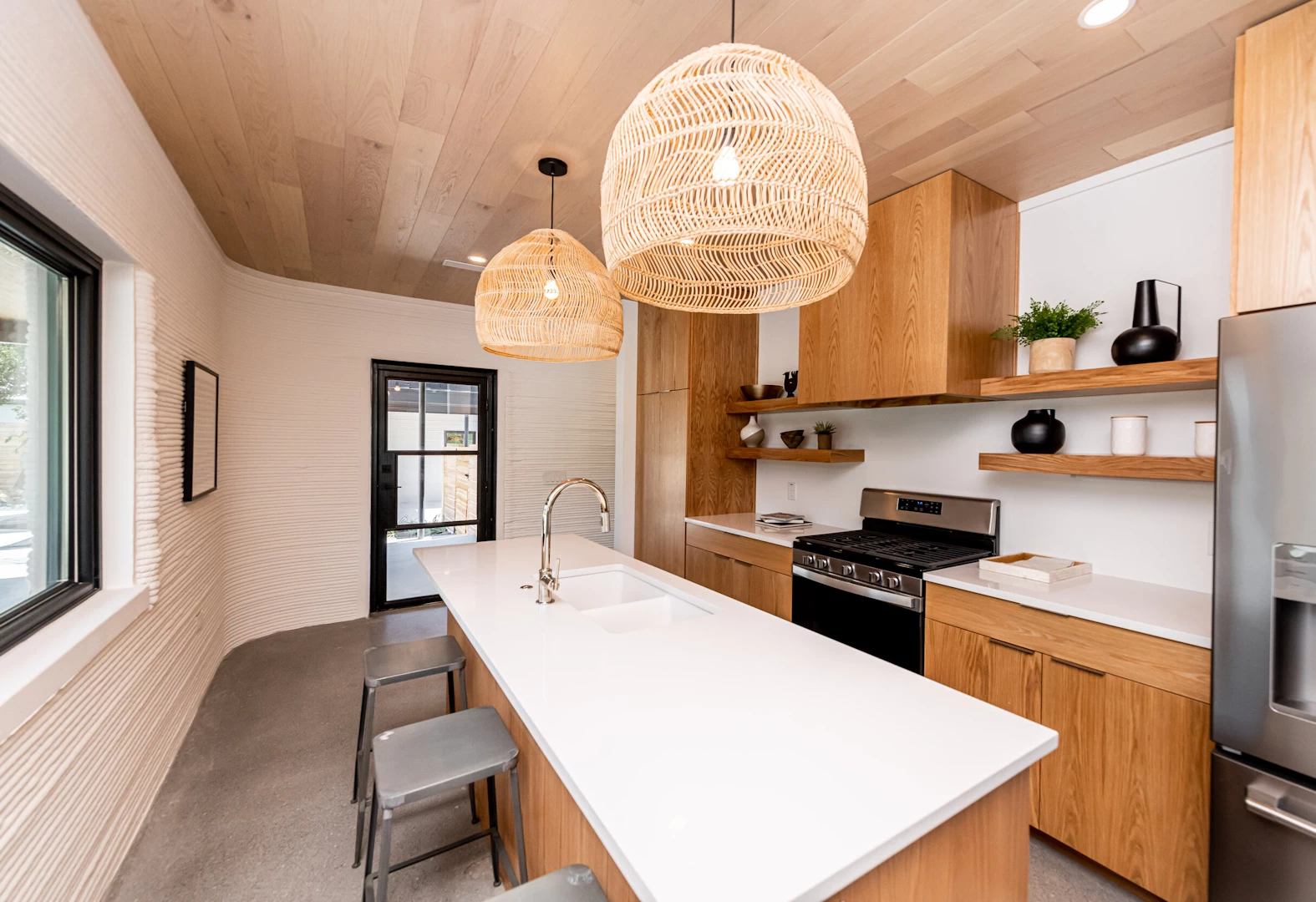 View of kitchen on ground floor of 3d printed concrete house with wooden ceiling