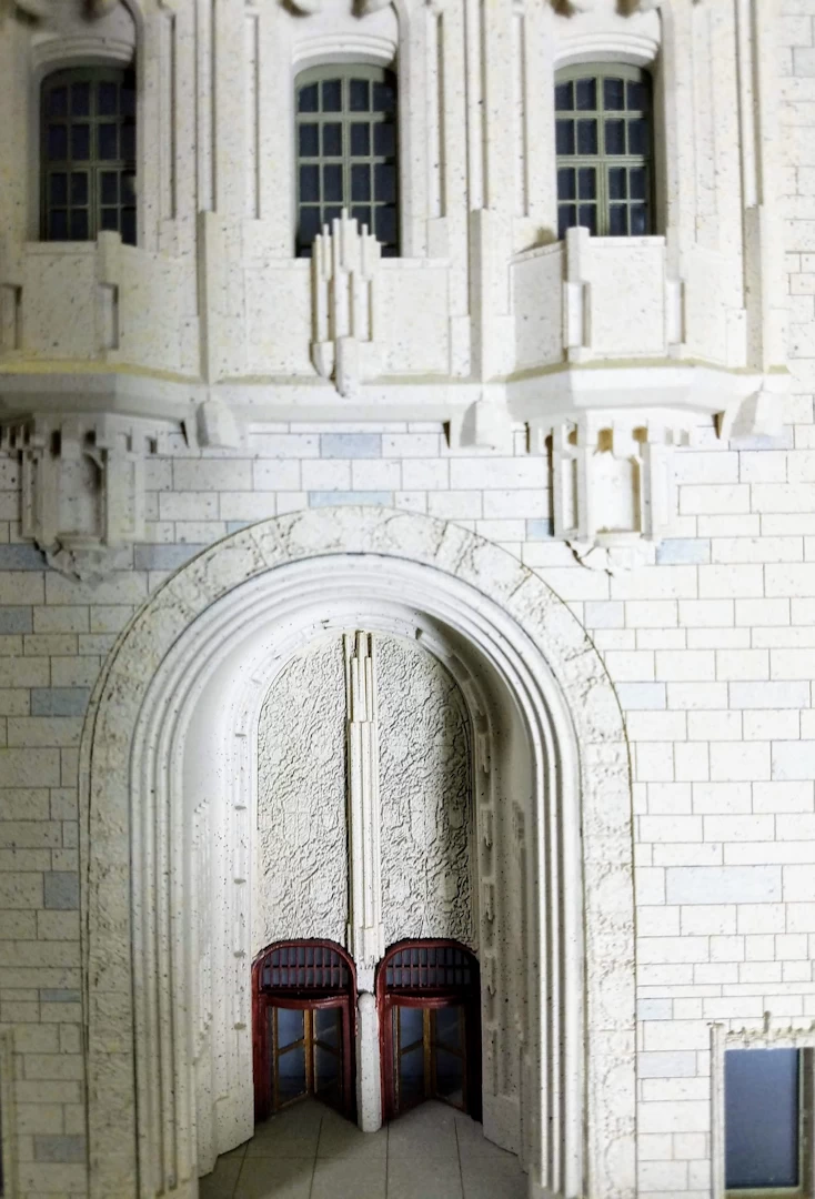 Entrance view of a white 3d printed model of gothic shaped building