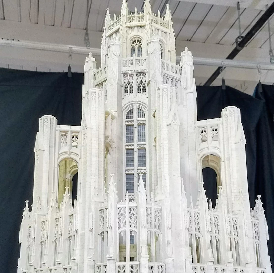 Front view of a white 3d printed model of gothic shaped building