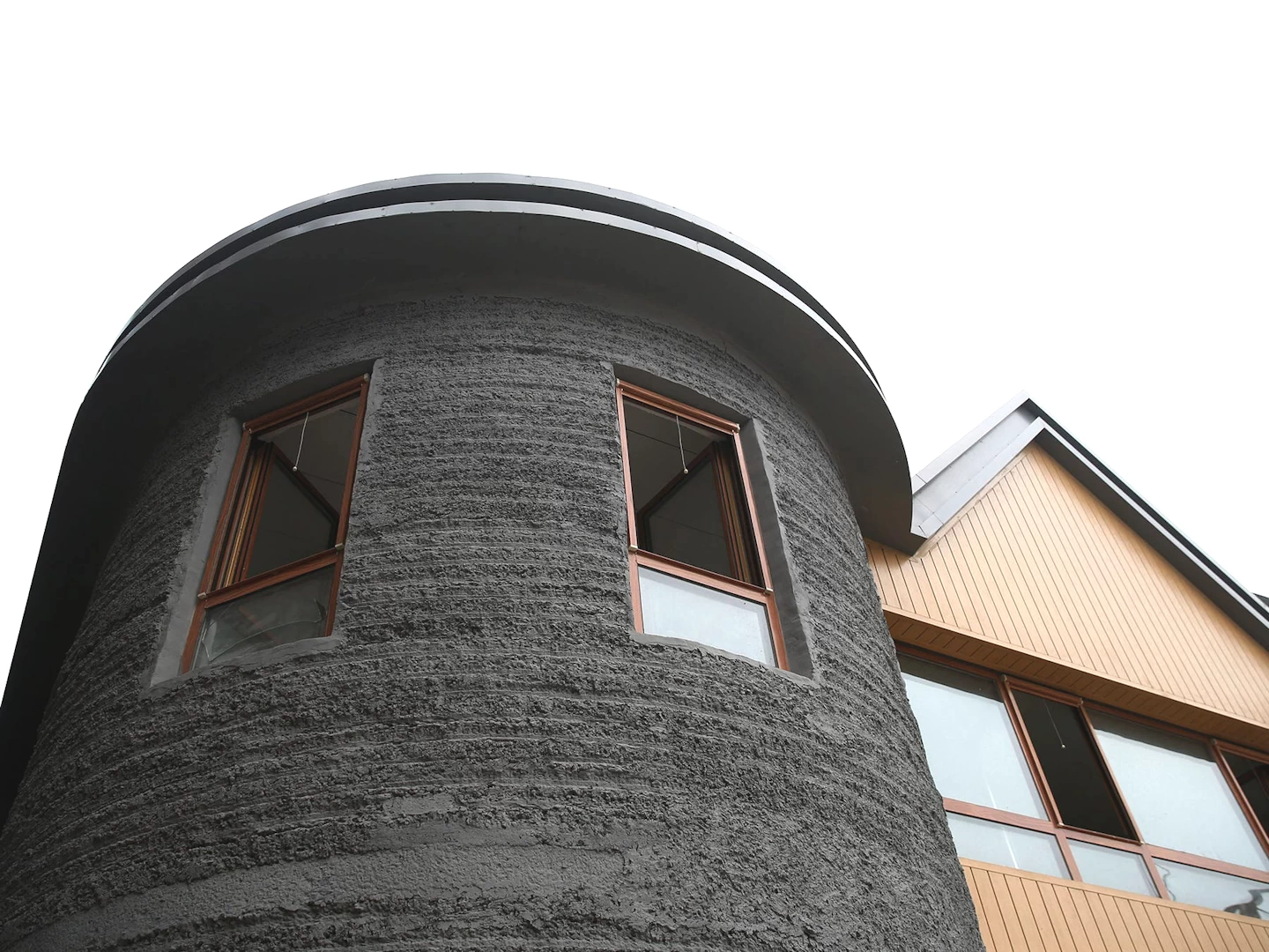 View of round corner on grey 3d printed double storey concrete house